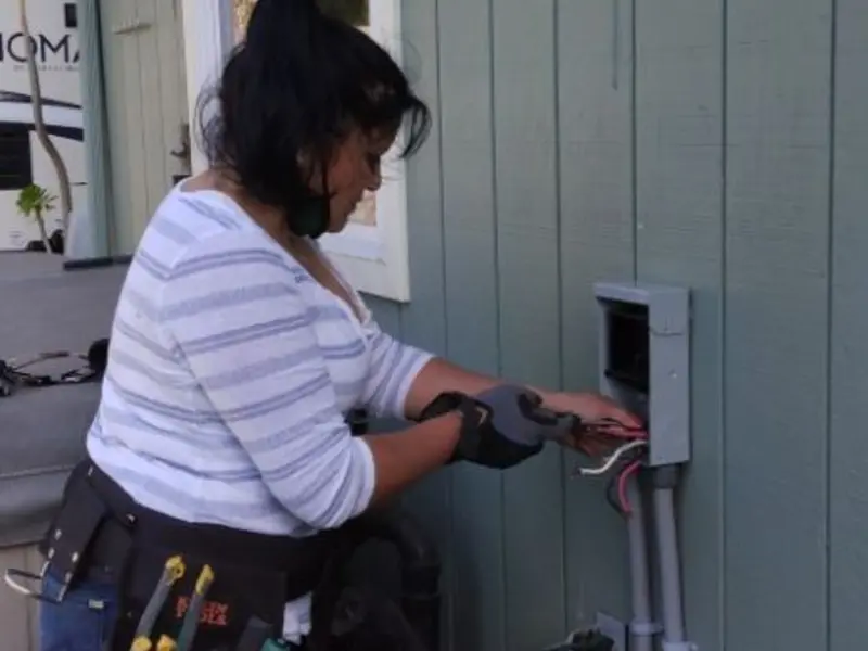 Licensed electrician wiring an exterior subpanel in Bainbridge